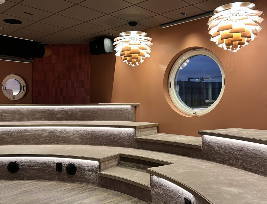Spännande eventmiljö med cirkulära fönster, unika ljusinstallationer och terrasserade sittytor.